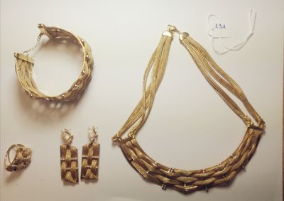 several pieces of jewelry are displayed on a white surface