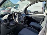 the interior of a small white car with a steering wheel and dashboard