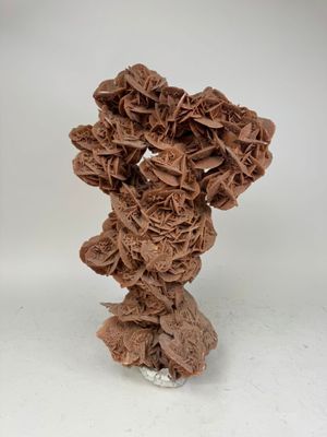a brown vase with a bunch of flowers in it
