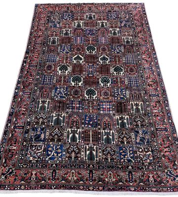 an antique persian rug with blue, red and black colors
