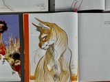 sketches of a cat and a dog in a book on a table