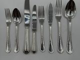 five forks and five spoons on the table