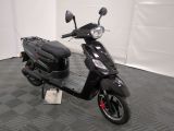 the motor scooter is parked on the floor in the garage