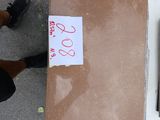 a person standing next to a box with a sign on it