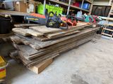 many pieces of wood stacked on top of each other in a garage