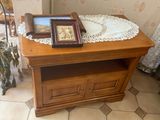 a wooden table with a picture frame on top of it