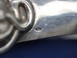 a close up of a metal object on a blue surface