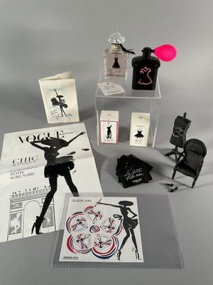 an image of a collection of perfumes and cards on a table