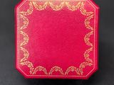 a small red box with a gold design on it