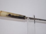 a knife that is hanging on the wall