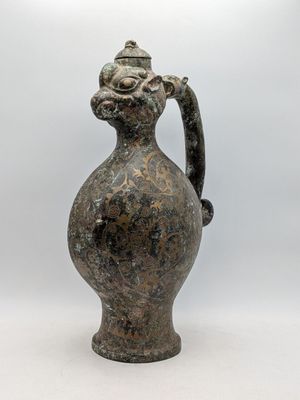 a small vase with a handle on a white background