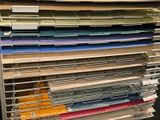 a lot of folders that are stacked up on a rack