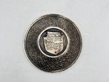 an image of a silver coin with a coat of arms on it