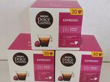 three boxes of coffee sitting on top of each other on a table