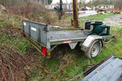 a trailer with a trailer attached to it in the grass