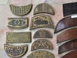 a lot of different types of leather belts on the floor