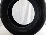 a close up of a tire on a white surface with a white curtain in the background