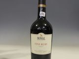a bottle of wine sitting on a table next to a glass of wine