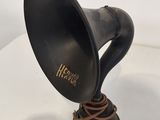 an old fashioned black horn on a white surface