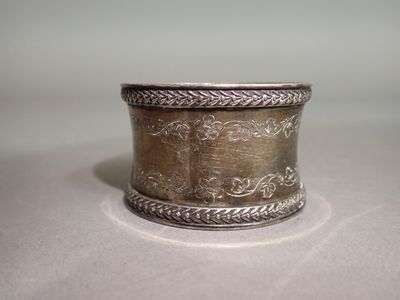 a silver ring that is sitting on a table