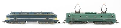 two toy trains sitting side by side on a white surface