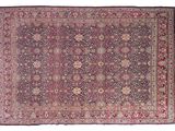 an antique persian rug with a floral design