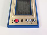 a blue and silver electronic device sitting on a white surface