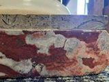 a red and white vase sitting on a table