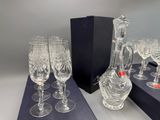 many wine glasses and a decanter on the table