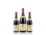 three bottles of wine sit side by side on a white surface