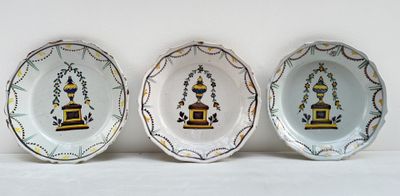 trois assiettes ornées de motifs décoratifs posées sur une surface blanche
