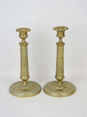 pair of antique brass candlesticks on a white background