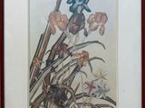 framed picture of a painting of flowers in a vase on a table