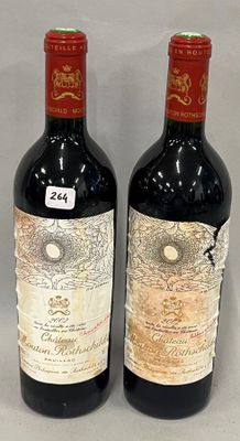 two bottles of red wine sitting next to each other on a table