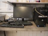 a desk with a computer, keyboard, and mouse on it