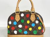 a louis vu vu polka dot handbag on a table