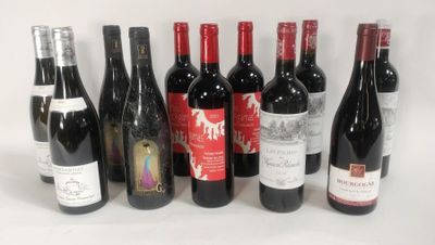 several bottles of wine are lined up in a row on a white surface