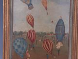 painting of a group of hot air balloons flying in the sky