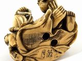 a figurine of a man on a motorcycle with a bird on it