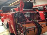 a large red fire truck parked inside of a building
