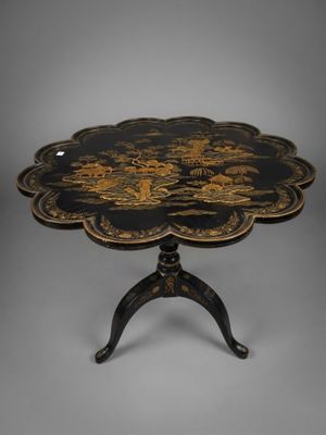a black and gold table with a flower design on it