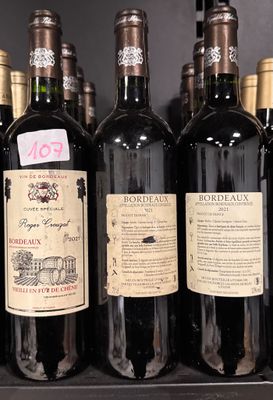 several bottles of wine sit on a shelf in a store