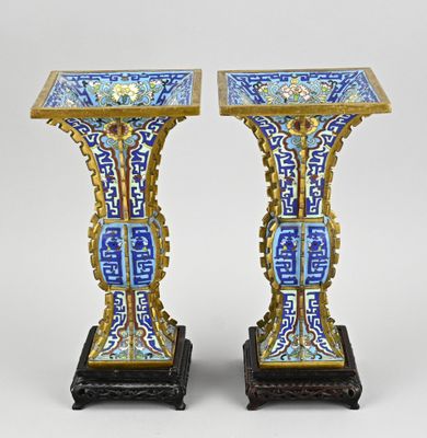 pair of blue and gold vases with oriental designs on them