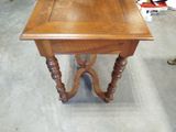 a small table with a wooden top in a room