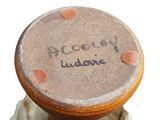 a brown vase with writing on it sitting on a table