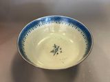 a blue and white bowl sitting on a table