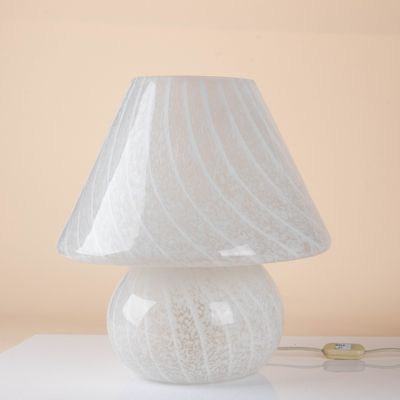 a white lamp that is sitting on a table