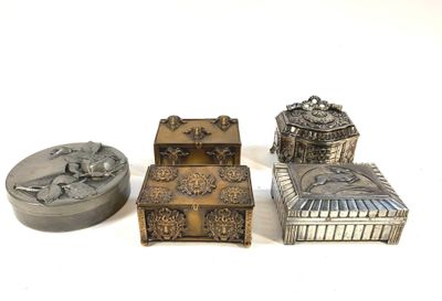 three silver metal boxes sitting next to each other on a white surface