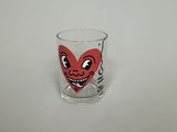 a shot glass with a red heart on it