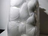 a large pile of white balls wrapped in plastic